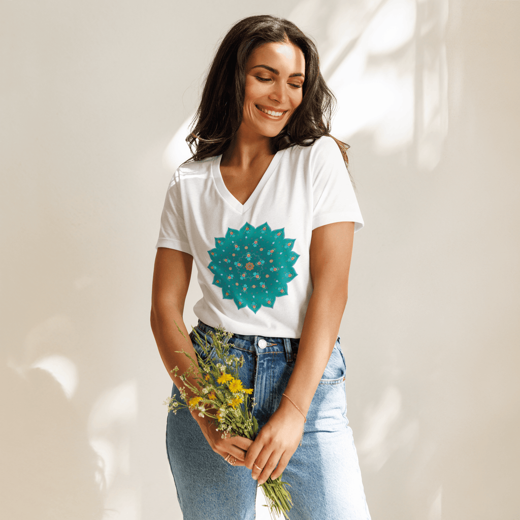 Women wearing Teal Mandala Tee in white and jeans, holding flowers